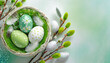 Green Easter background with Easter eggs in a basket and catkins