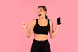© Prostock-studio - Energetic young woman in sportswear dancing and enjoying music from her smartphone