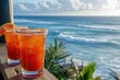 Bright red Michelada cocktails with salty rimmed glasses shine on a private oceanfront veranda for brunch
