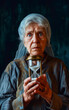 An elderly woman holds an hourglass in her hand, a symbol of time that passes inexorably