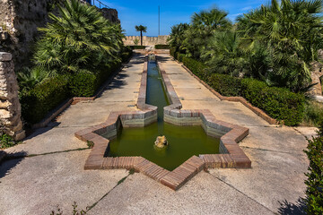 Wall Mural - Xativa Castle or Castillo de Xativa - ancient fortification on the ancient roadway Via Augusta in Spain. Moorish pool and star shape fountain. Xativa, Spain, Europe.