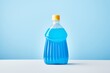 a blue bottle of fabric softener with a plain background