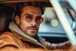 A rugged man with a beard and glasses, clad in a leather jacket, gazes confidently at the camera while leaning against his car, exuding a cool and mysterious aura