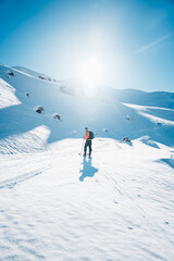 Wall Mural - A man on ski alpine tour throught snowy Alps in Switzerland or Austria, Backcountry skier in Alps