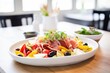 © altitudevisual - antipasto platter with olives, cheese, and peppers