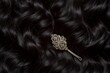 macro shot of an antique silver hairpin in dark curly hair