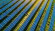 © Davin - Aerial view over two technician walking for inspecting operation efficiency of solar panel energy production field solar farm in countryside area with sunset.