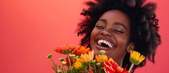 Poster - A joyful African American woman holding a bouquet and smiling.