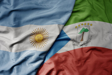 Wall Mural - big waving national colorful flag of equatorial guinea and national flag of argentina .