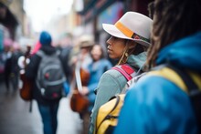Tourist With A Backpack Watching A Street Musician Perform