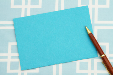 Wall Mural - Blank blue greeting card and pen
