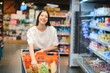 © Serhii - Groceries Shopping. Portrait Of Smiling Happy Woman Leaning On Trolley Cart In Supermarket