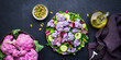 Vegan salad from purple cauliflower, chicken breast, fresh cucumbers, onion, radicchio, spinach and pumpkin seeds, black background, top view