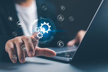 concept of automation software technology process systems, innovations for managing business work processes , businessman touch a gear icon showing the operation of robotic automation software