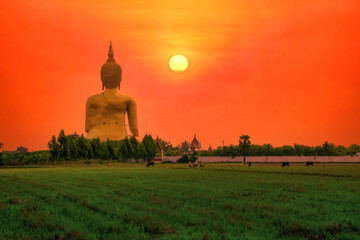 Wall Mural - Big Statue buddha image at sunset in southen of Thailand