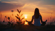 © Andrei - Beautiful meditation woman silhouette in sunset aura, in the nature, sitting on the grass. Yoga practice  relaxation for community with nature and earth.