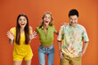 © LIGHTFIELD STUDIOS - jolly multicultural teens in casual vivid attires having fun and looking at camera, friendship day