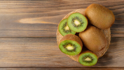 Wall Mural - Top view tasty ripe kiwi on wooden background with copy space