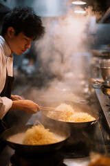 Wall Mural - Asian male chef making ramen in the kitchen.