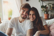 © MNStudio - Romantic happy young couple relaxing on couch at home. Loving spouses resting in cozy living room interior. People in love enjoying weekend time together.