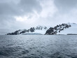 © Vladimir Drozdin - A huge high breakaway glacier in the southern ocean off the coast of Antarctica, the Antarctic Peninsula, the Southern Arctic Circle, azure water, cloudy weather