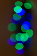 circles of lights in green and blue in circles on dark background