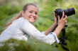 female photographer using tripod in the countryside