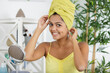 woman with towel on her head looking at camera