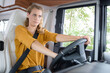 upset woman driving on a road in the camper van