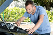 a man fixing car oudtoors