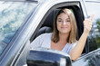 female car driver making thumbs-up gesture