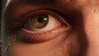 
A close-up of a man's face a tear in his eye, like he did something wrong. 
