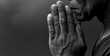© herlanzer - black man praying to god with black grey background with people stock image stock photo