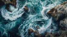 Nature's Relentless Power Is On Full Display As Crashing Waves Engulf The Rocky Shore, Their Aqua Hues Contrasting Against The Vast Expanse Of The Ocean