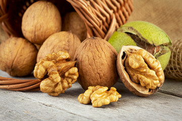 Poster - Walnut kernels and whole walnuts on rustic wooden table. Healthy walnuts.