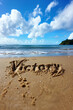 Victory Written in the Sand - Inspirational word written on a sandy beach Gen AI