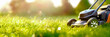 Lawn mower on green grass. Gardening concept background. Panoramic banner