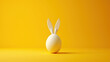  a white egg with a rabbit's tail sticking out of it's side on a yellow background with a yellow background.
