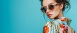 © The 2R Artificiality - Fashion model wearing stylish sunglasses poses in the studio in a fashionable dress.