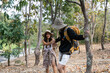 © itchaznong - Happy LGBT Lesbian couple Travelers Hiking with Backpacks in forest Trail. LGBT Lesbian Couple Hikers with backpacks walks in mountains in vacation