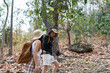 © itchaznong - Happy LGBT Lesbian couple Travelers Hiking with Backpacks in forest Trail. LGBT Lesbian Couple Hikers with backpacks walks in mountains in vacation