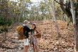 © itchaznong - Happy LGBT Lesbian couple Travelers Hiking with Backpacks in forest Trail. LGBT Lesbian Couple Hikers with backpacks walks in mountains in vacation