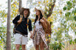 © itchaznong - Happy LGBT Lesbian couple Travelers Hiking with Backpacks in forest Trail. LGBT Lesbian Couple Hikers with backpacks walks in mountains in vacation