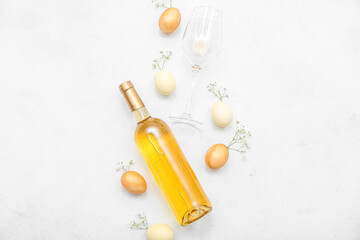 Wall Mural - Composition with bottle of wine, glass, Easter eggs and gypsophila flowers on light background