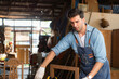 © Wosunan - Carpenter working at his carpentry shop. Eyesight is utilized to ensure accuracy.