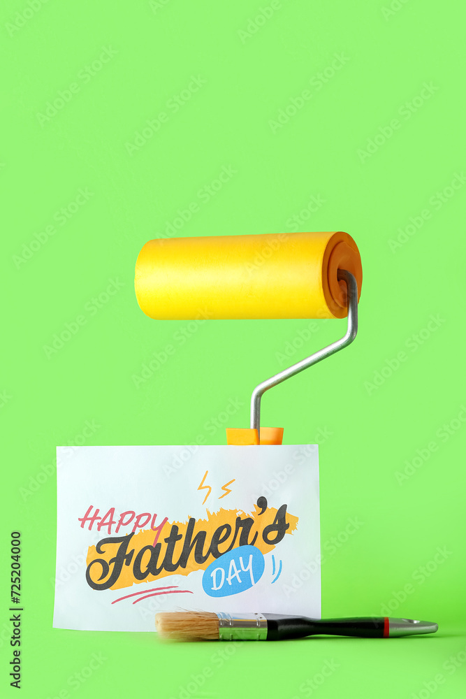 Card for Father's Day with paint roller and brush on green background