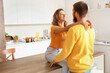 © Pixel-Shot - Happy couple in love hugging in kitchen