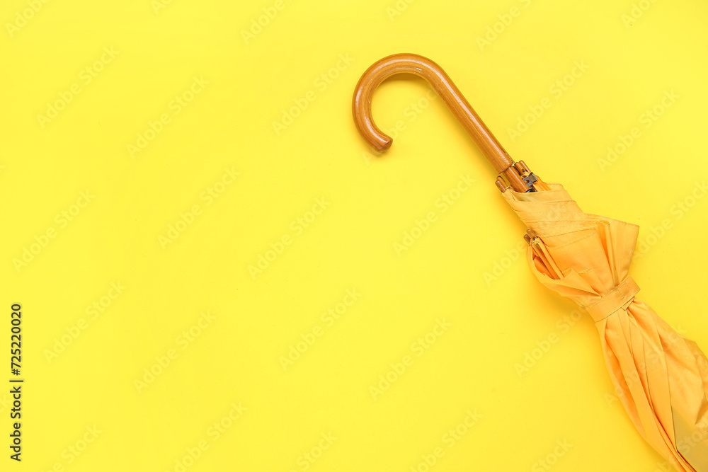 Yellow stylish umbrella on color background