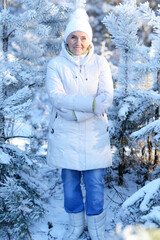 Wall Mural - Happy old woman in a fur coat in the winter. 