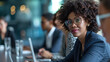 © Postproduction - Focused business woman working on laptop during meeting. Corporate professionalism.